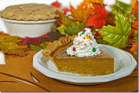 stock-photo-pumpkin-pie-slice-with-fall-leaves-and-pumpkin-64281358